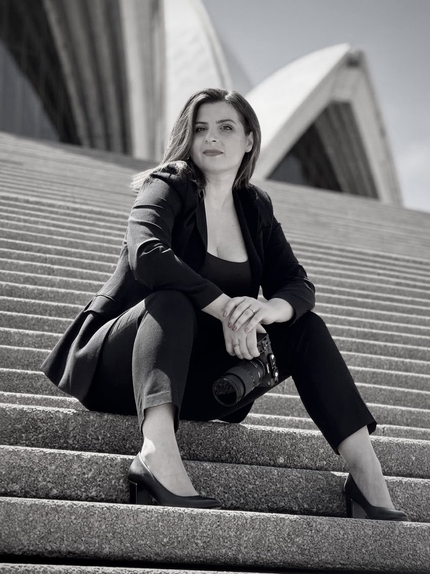 Anna on the steps of the Sydney Opera House, camera in hand