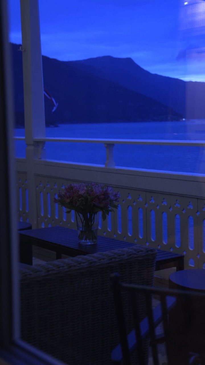 The balcony at Kviknes Hotel at blue hour, the fjord and mountains beyond